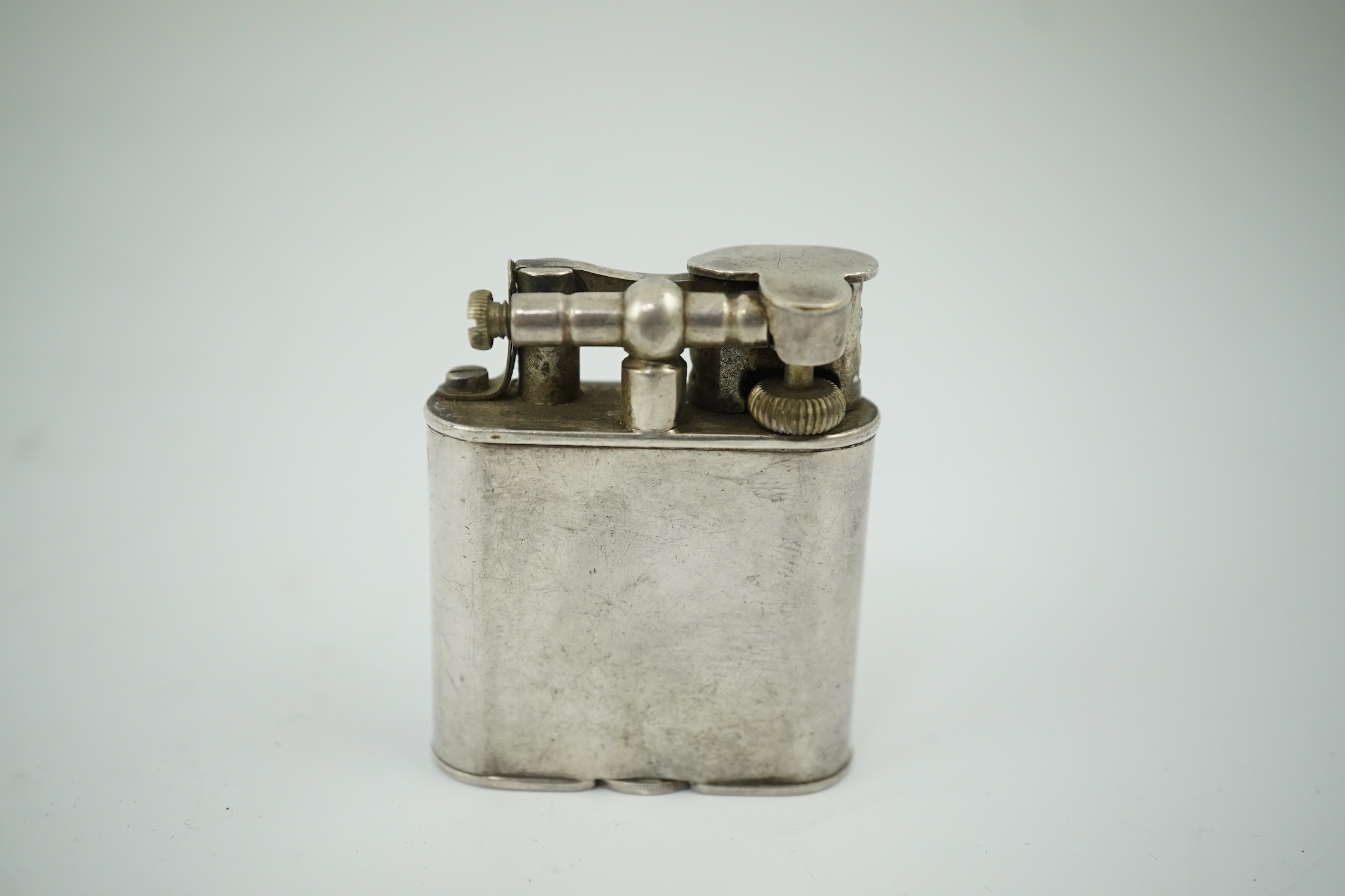 An Edwardian Dunhill cigarette lighter with unmarked crested white metal banding and patent no.288806, height 49mm. Condition - poor to fair